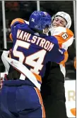  ?? JOSEPH D. SULLIVAN — NEWSDAY VIA AP ?? The Islanders’ Oliver Wahlstrom fights with the Flyers’ Travis Sanheim during the third period Tuesday in Uniondale, N.Y.