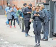  ??  ?? Customers wait in line in the alley before being allowed inside Wines Off Wynkoop liquor store on Monday in Denver.