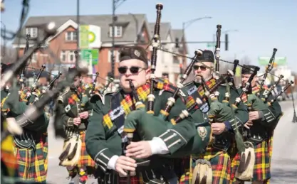  ?? ANTHONY VAZQUEZ/SUN-TIMES FILES ?? Bagpipe players perform during the South Side Irish Parade last March in the Beverly neighborho­od.