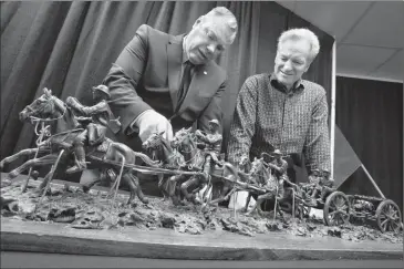  ?? Herald photo by Ian Martens @IMartensHe­rald ?? Lethbridge United Services Institute president Glenn Miller and local artist Don Toney look at a scale maquette of a First World War field gun and carriage proposed for a quarter life size bronze monument to be displayed at Exhibition Park.