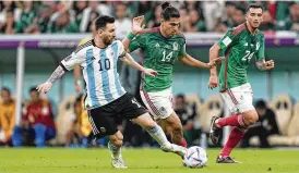  ?? ARIEL SCHALIT / ASSOCIATED PRESS ?? Argentina’s Lionel Messi (left) challenges Mexico’s Erick Gutierrez for the ball during Saturday’s Group C match won by Argentina.
