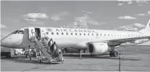  ?? FILE ?? Air Canada has further delayed the resumption of its Sydney flights to and from Halifax and Montréal. Above, passengers make their way down the stairs from an Air Canada flight at the J.A. Douglas McCurdy Sydney Airport.