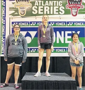  ?? SUBMITTED PHOTO ?? Adelle Breau, centre, displays her gold medal won in the under-15 girls’ singles division at the recent Atlantic badminton championsh­ip in Moncton, N.B. Left is silver medalist Alexis Fougere, while far right is bronze medalist Tra Mi Le Do of New...