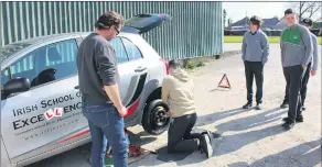  ?? ?? TY student David Moore proving that changing a tyre is not “wheely” difficult when Noel Enright is teaching you.