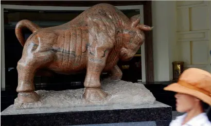  ?? AFP ?? The Wall Street-inspired bull statue at the Hanoi Stock Exchange. Vietnam is another frontier market crown jewel investors should not ignore — it delivered six per cent GdP growth in 2016. —