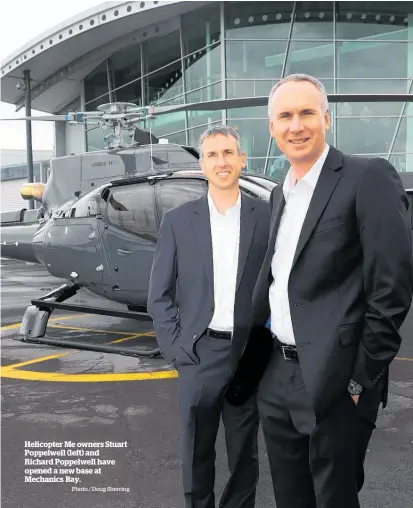  ?? Photo / Doug Sherring ?? Helicopter Me owners Stuart Poppelwell (left) and Richard Poppelwell have opened a new base at Mechanics Bay.