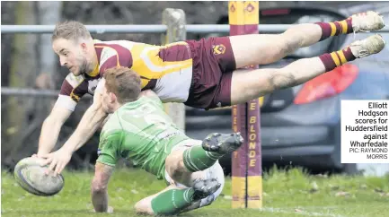  ??  ?? Elliott Hodgson scores for Huddersfie­ldagainst Wharfedale PIC: RAYMONDMOR­RIS