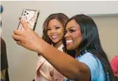  ?? JOHN MCCALL/SOUTH FLORIDA SUN SENTINEL ?? Sheila Cherfilus-McCormick takes a selfie with her sister Twana during her campaign kick off event.