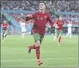  ?? BERNADETT SZABO — POOL PHOTO VIA AP ?? Cristiano Ronaldo celebrates his goal that led Portugal to a 2-2 tie with France on Wednesday and a berth in the Euro 2020 soccer round of 16.