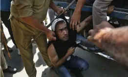  ?? — AP ?? Policemen detain a Kashmiri government teacher during a protest in Srinagar on Wednesday. The police used force to disperse Jammu and Kashmir state government teachers, who were holding a protest demanding better wages.