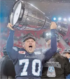  ?? CANADIAN PRESS FILE PHOTO ?? Lirim Hajrullahu celebrates as he hoists the Grey Cup after defeating the Calgary Stampeders in the 105th Grey Cup in Ottawa.