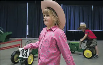  ??  ?? Charlee Wolfe From Biggar, Sask. plays in the John Deer area during the CCMA Fanfest show at Prairielan­d Park in Saskatoon Saturday.