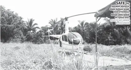  ??  ?? The helicopter piloted by Mayor Anthony Joseph Inton of Hermosa, Bataan safely landed on a grassy area.