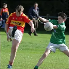  ??  ?? William Foley of Horeswood kicks the ball past Leo Sinnott (Kilmore).