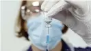  ??  ?? A nurse prepares the BioNTech-Pfizer vaccine. It's been shown to have reduced efficacy against the South Africa variant of COVID-19