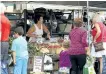  ?? CLIFFORD SKARSTEDT/EXAMINER ?? Shoppers buy produce from the Kent Farms stand on Saturday at the Peterborou­gh Farmers' Market at Morrow Park.