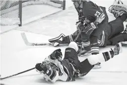  ?? AP ?? Capitals left winger Alex Ovechkin, front, shoots over his head after being checked to the ice by Coyotes defenseman Paul Mara (23), past Coyotes goalie Brian Boucher, rear, for a goal on Jan. 16, 2006, at Gila River Arena in Glendale.