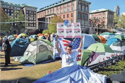  ?? CHARLY TRIBALLEAU/AFP VIA GETTY IMAGES ?? A pro-israel protester stands in the pro-Palestian encampment on the campus of Columbia University in New York City on Wednesday.