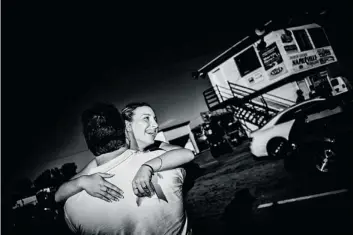  ??  ?? First time out:
Jordan Schnabel, 16, hugs her father, Keith, after winning the First Time Racer and Ladies trophies in her first time out
as an adult driver.