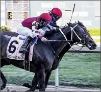  ?? The Sentinel-Record/GRACE BROWN ?? Hall of Fame jockey Mike Smith rides Midnight Bisou (6) past Escape Clause and jockey Tyler Baze to win the Apple Blossom Handicap at Oaklawn Park on Sunday.