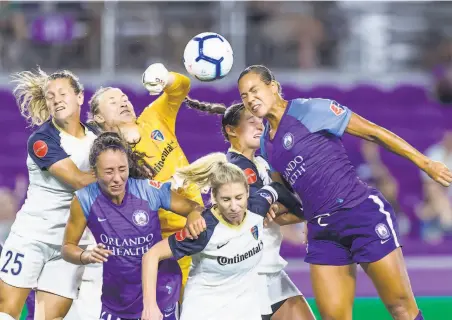  ?? Icon Sportswire via Getty Images ?? North Carolina Courage goalie Sam Leshnak (in yellow) makes a punch save during a NWSL match against the Orlando Pride.