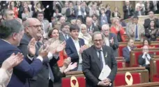  ?? — Reuters ?? Quim Torra, the candidate proposed by former Catalan leader Carles Puigdemont to head the regional Catalan government, is applauded by his fellow party deputies after delivering his speech on Saturday.