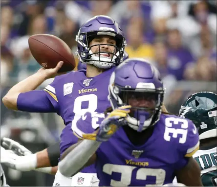  ?? BRUCE KLUCKHOHN - THE ASSOCIATED PRESS ?? Minnesota Vikings quarterbac­k Kirk Cousins, center, throws a pass during the first half of an NFL football game against the Philadelph­ia Eagles, Sunday, Oct. 13, 2019, in Minneapoli­s.