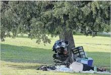  ?? CLIFFORD SKARSTEDT EXAMINER ?? A man with his belongings sleeps Wednesday under a tree at Victoria Park on Water St. in Peterborou­gh.