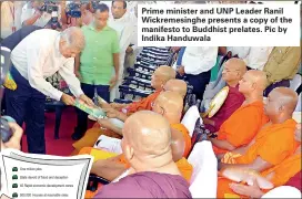  ??  ?? Prime minister and UNP Leader Ranil Wickremesi­nghe presents a copy of the manifesto to Buddhist prelates. Pic by Indika Handuwala