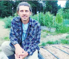  ?? DEAN FOSDICK/THE ASSOCIATED PRESS ?? Seth Raabe, an agricultur­e teacher, prepares plant beds for students to cultivate when they return to classes from summer vacation, helping them learn many valuable life skills.