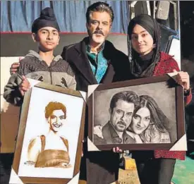 ??  ?? Anil Kapoor with his young fans, Meet and Simran, who gifted him these sketches