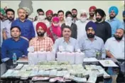  ??  ?? Special task force members along with other officials showing the recovered cash and heroin in Amritsar. HT FILE