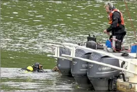  ?? Darrell Sapp/Post-Gazette ?? RESCUE OPERATION A diver returns to the Pittsburgh River Rescue unit Wednesday while searching the Monongahel­a River after a person reportedly jumped from the Homestead Grays Bridge.
