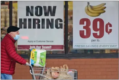  ?? (AP) ?? A man walks out of a Marc’s Store in Mayfield Heights, Ohio, earlier this month. Fewer Americans applied for unemployme­nt benefits last week, lowering claims to 900,000, still a historical­ly high level.