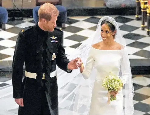  ?? OWEN HUMPHREYS AP ?? Britain's Prince Harry and Meghan Markle leave after their wedding ceremony at St. George's Chapel in Windsor Castle on Saturday.