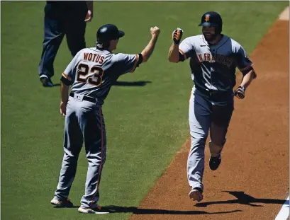  ?? DENIS POROY — GETTY IMAGES ?? The Giants’ Darin Ruf is congratula­ted by Ron Wotus after hitting a two-run home run during the second inning against the Padres.