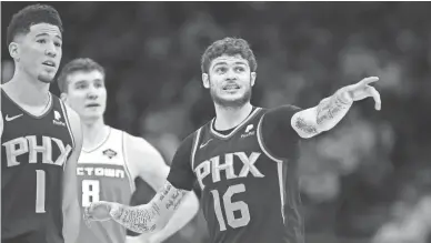  ?? PHOTOS BY SERGIO ESTRADA/USA TODAY SPORTS ?? Suns guard Tyler Johnson (16) talks with guard Devin Booker during the fourth quarter against the Kings at Golden 1 Center in Sacramento on Sunday.