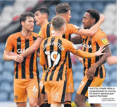  ?? CAMERASPOR­T - DAVE HOWARTH ?? Hull City’s Mallik Wilks is congratula­ted on scoring his team’s opening goal against Rochdale