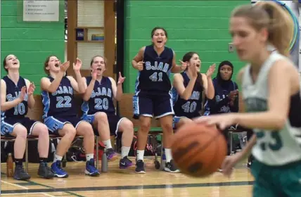  ?? DAVID BEBEE, RECORD STAFF ?? Members of the Sir John A Macdonald Highlander­s bench celebrate a valuable two points from free throws as Waterloo Oxford Crusaders’ Madeline Woolvett retrieves the ball. The points helped to decide an excitingly close game in which SJAM upset their...