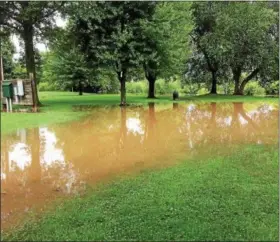  ?? EVAN BRANDT — DIGITAL FIRST MEDIA ?? As so often happens in heavy rains, the Manatawny Creek flooded low-lying areas of Memorial Park in Pottstown on Aug. 13.