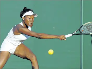  ?? KRISTY WIGGLESWOR­TH/AP ?? Canada’s Francoise Abanda returns to Jelena Ostapenko during their match Wednesday at the Wimbledon Tennis Championsh­ips in London. Ostapenko beat Abanda 4-6, 7-6 (3), 6-3.