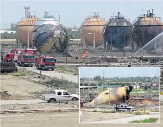  ?? Picture: AFP ?? Firefighte­rs put out the blaze which, inset, destroyed gas tanks in Taji yesterday