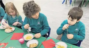  ??  ?? Children at Bollington St John’s Primary enjoy their Chinese feast