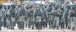  ??  ?? Riot police approach a protest site in Hong Kong on Wednesday.