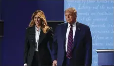  ?? JULIO CORTEZ
AP PHOTO/ ?? President Donald Trump and first lady Melania Trump hold hands on stage after the first presidenti­al debate at Case Western University and Cleveland Clinic, in Cleveland, Ohio, Sept. 29.