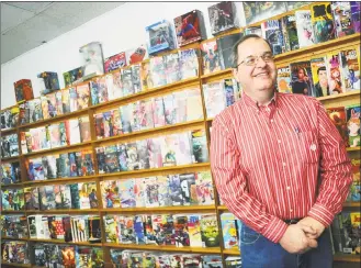  ?? Michael Cummo / Hearst Connecticu­t Media ?? Paul Salerno, owner of A Timeless Journey comic shop, inside his store in Stamford on Wednesday. Salerno is shuttering his store at the end of the month. At right, The Walking Dead action figures.