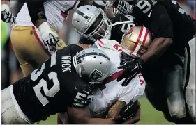  ?? — GETTY IMAGES ?? Justin Tuck, right, Antonio Smith, centre, and Khalil Mack of the Raiders sack 49ers quarterbac­k Colin Kaepernick.