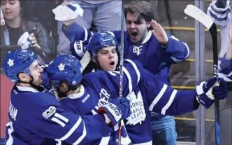  ?? FRANK GUNN, THE CANADIAN PRESS ?? The Toronto Maple Leafs’ Auston Matthews, right, celebrates his playoff breakout goal Monday against the Washington Capitals with rookie linemates Zach Hyman, left, and William Nylander.