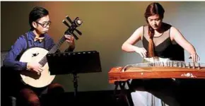  ??  ?? Neil Chua (left) and heng Xi ying mesmerised the audience with their performanc­e, which gave a modern twist to classical Chinese pieces.