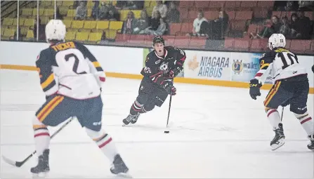  ?? BOB TYMCZYSZYN
THE ST. CATHARINES STANDARD ?? Niagara IceDogs’ Philip Tomisino (26) carries the puck into the Erie Otters end in an OHL exhibition game in Thorold Friday.